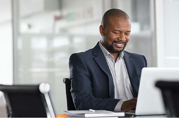 businessman using work computer to view home banking